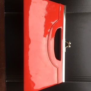 Red patent leather clutch w/ shoulder strap